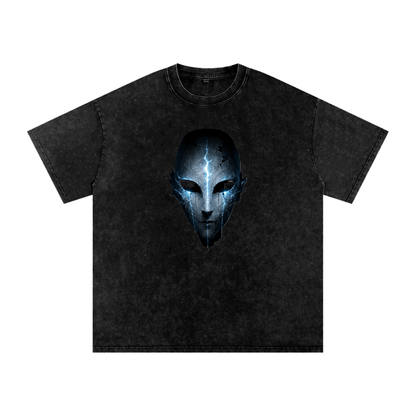 Void Sentinel Snow Wash Tee in Black — front view showing cracked spirit mask chest graphic with cold blue glowing eye sockets on washed oversized cotton tee